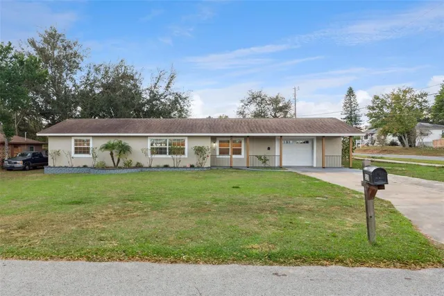 a front view of house with a garden