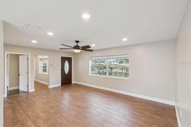 a view of an empty room with a fan