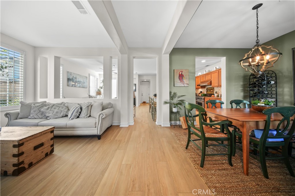 19 Sklar Street Ladera Ranch, CA 92694 - Photo 2 of 26 a living room with furniture and a chandelier