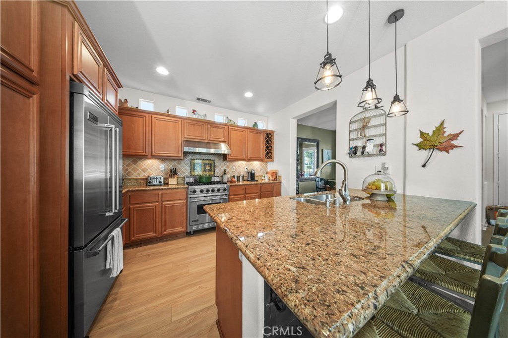 19 Sklar Street Ladera Ranch, CA 92694 - Photo 4 of 26 a kitchen with stainless steel appliances granite countertop a sink a stove and a refrigerator