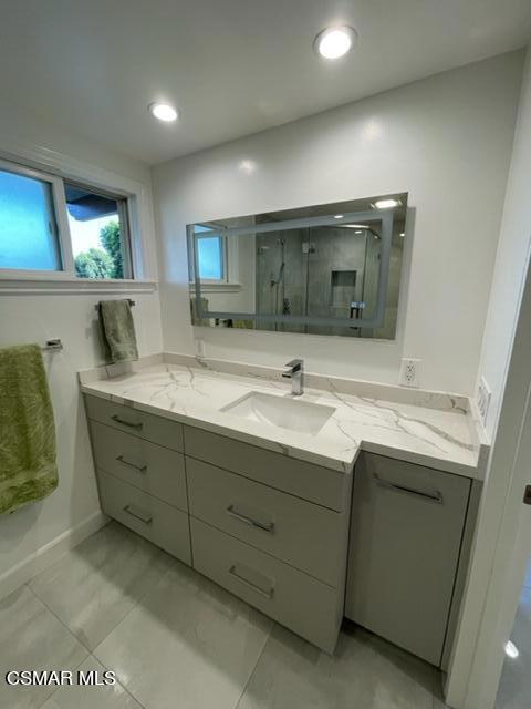 7869 Mesa Drive Simi Valley, CA 93063 - Photo 14 of 16 a bathroom with a double vanity sink and a mirror