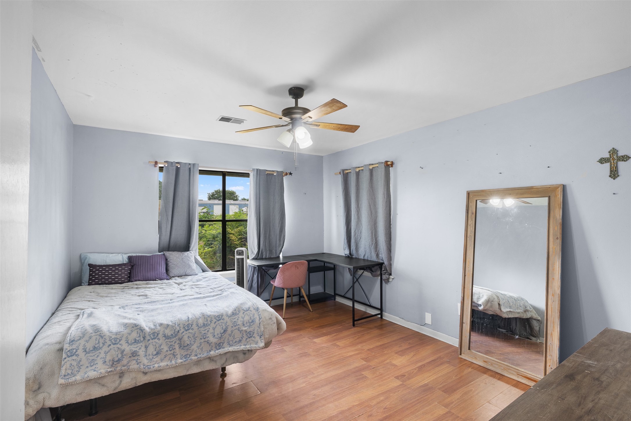 1015 FM 112 Road Lexington, TX 78947 - Photo 10 of 38 a bedroom with a bed and a chandelier