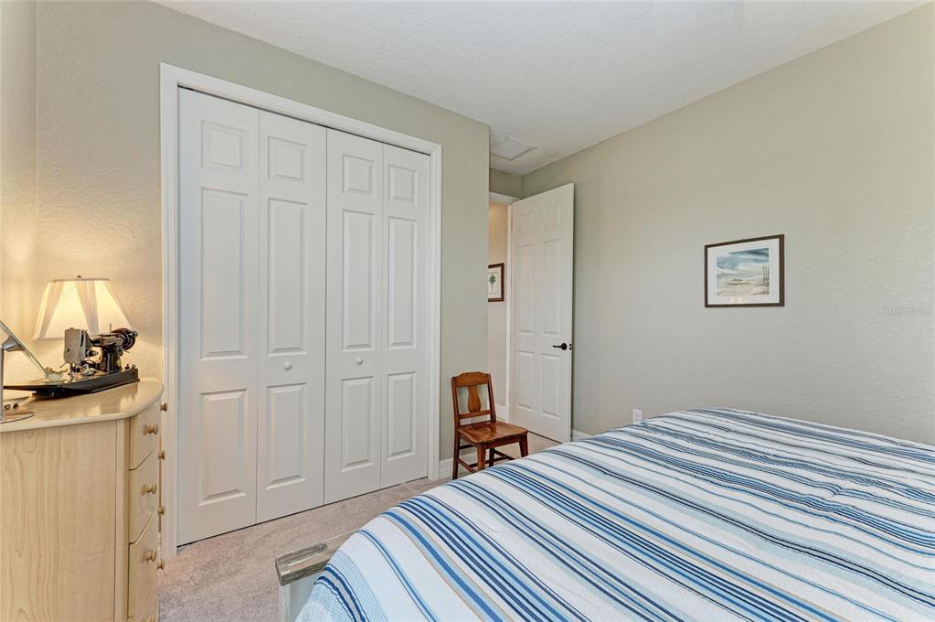 5810 Brandon Run Bradenton, FL 34211 - Photo 34 of 65 a bedroom with a bed and wooden floor