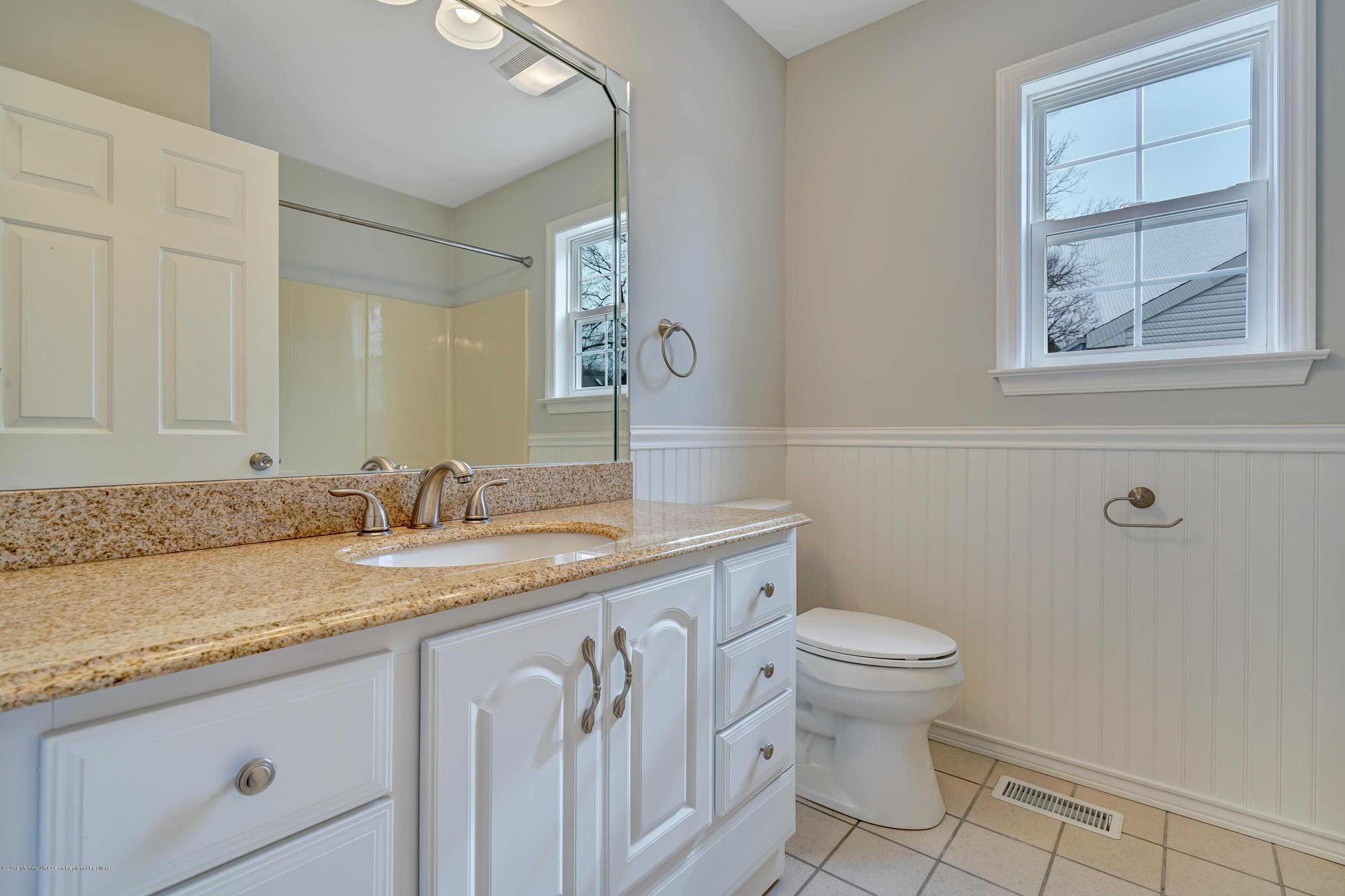 152 Bowline Road Manahawkin, NJ 08050 - Photo 16 of 29 a bathroom with a granite countertop sink a toilet and a mirror
