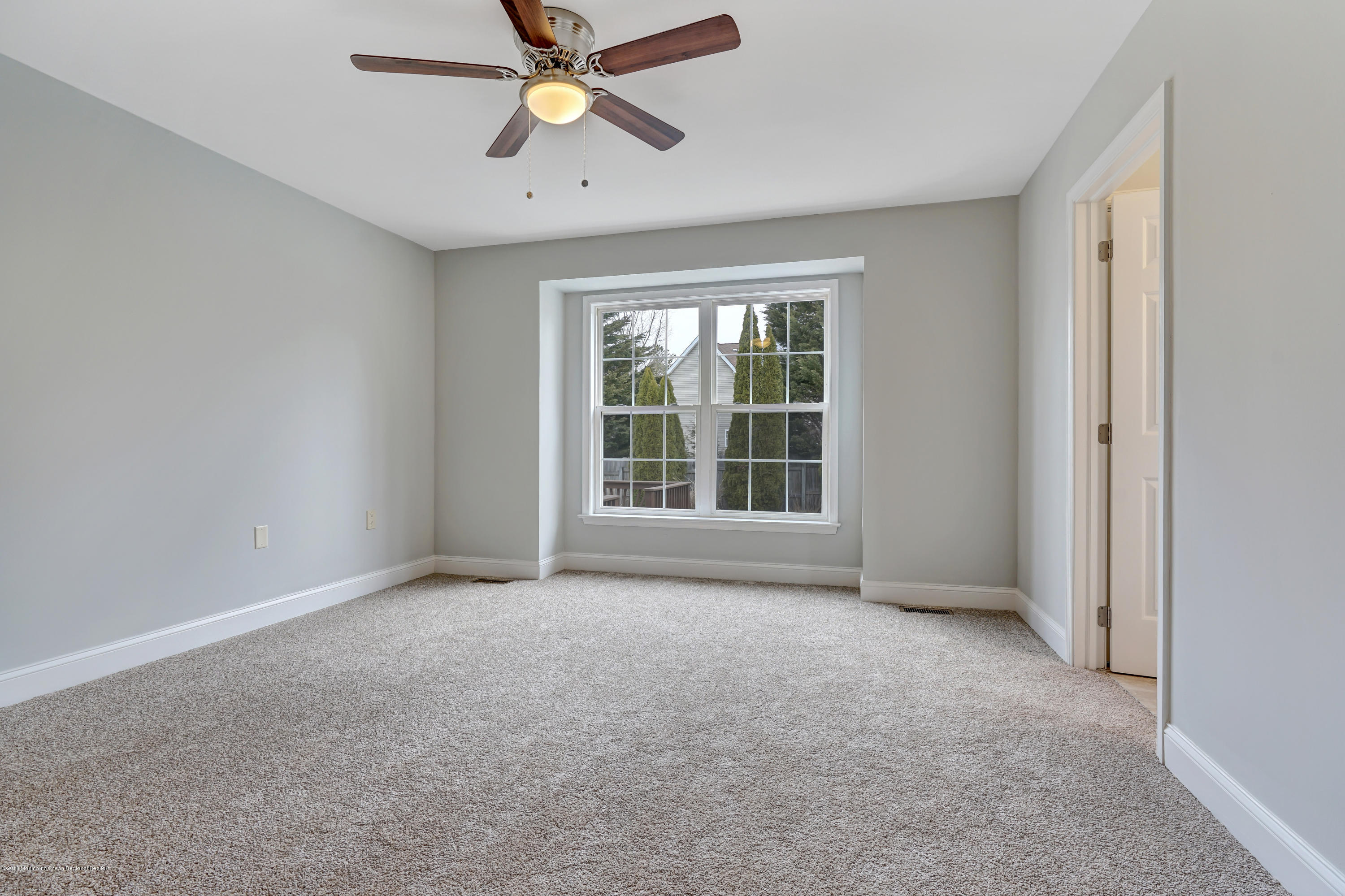 152 Bowline Road Manahawkin, NJ 08050 - Photo 17 of 29 an empty room with windows and fan