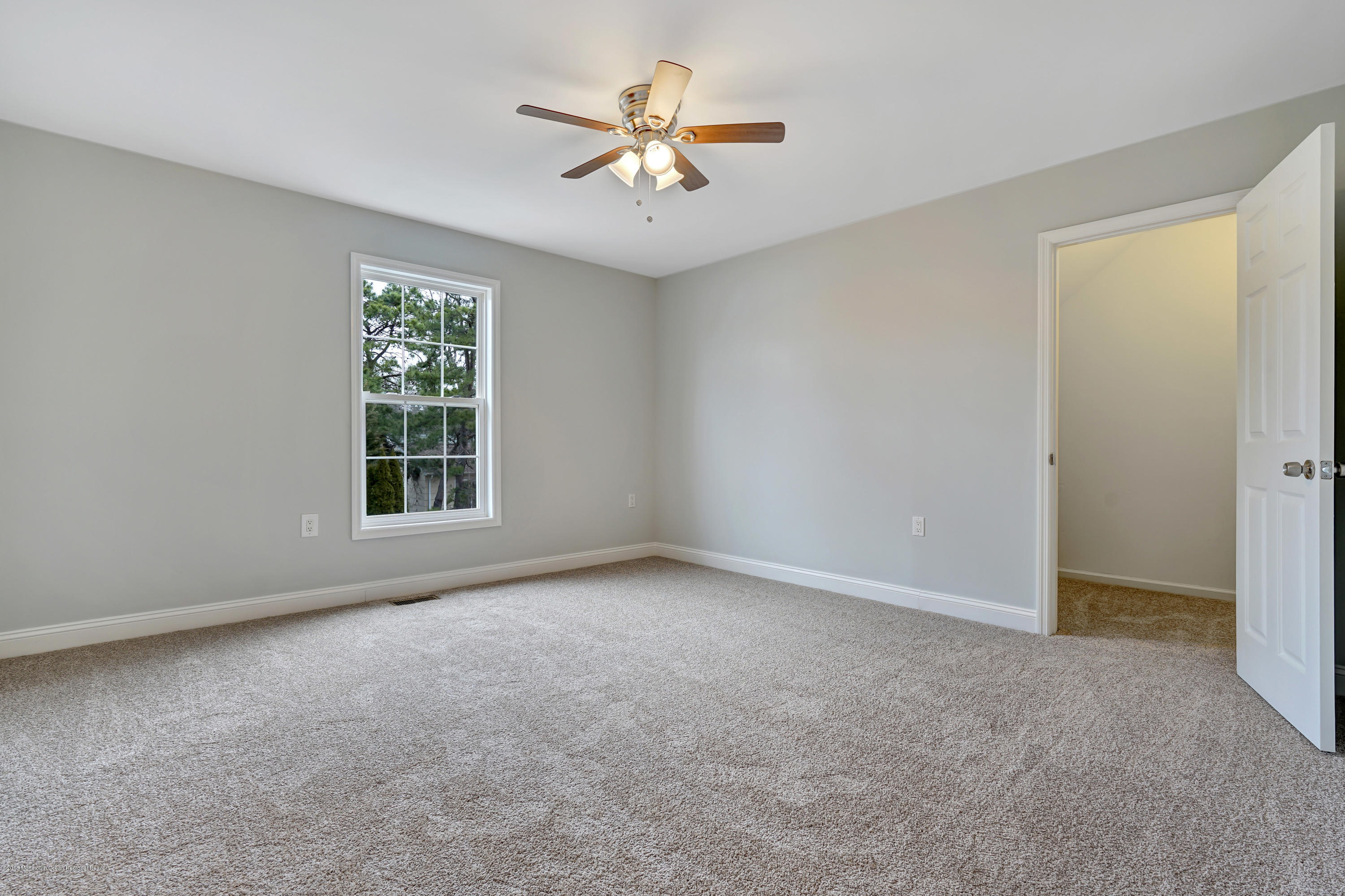 152 Bowline Road Manahawkin, NJ 08050 - Photo 22 of 29 an empty room with windows and fan