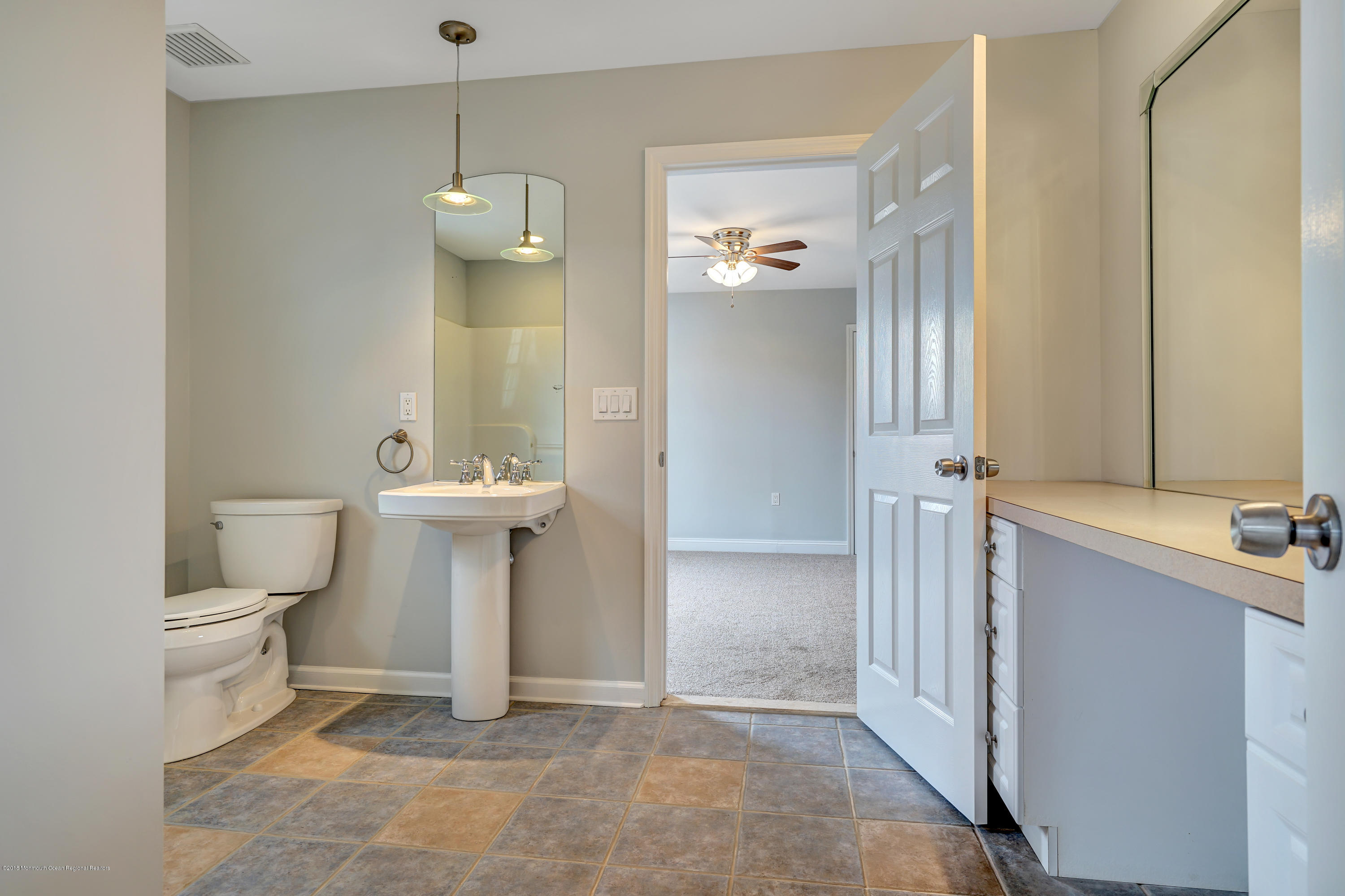 152 Bowline Road Manahawkin, NJ 08050 - Photo 25 of 29 a bathroom with a toilet sink and mirror