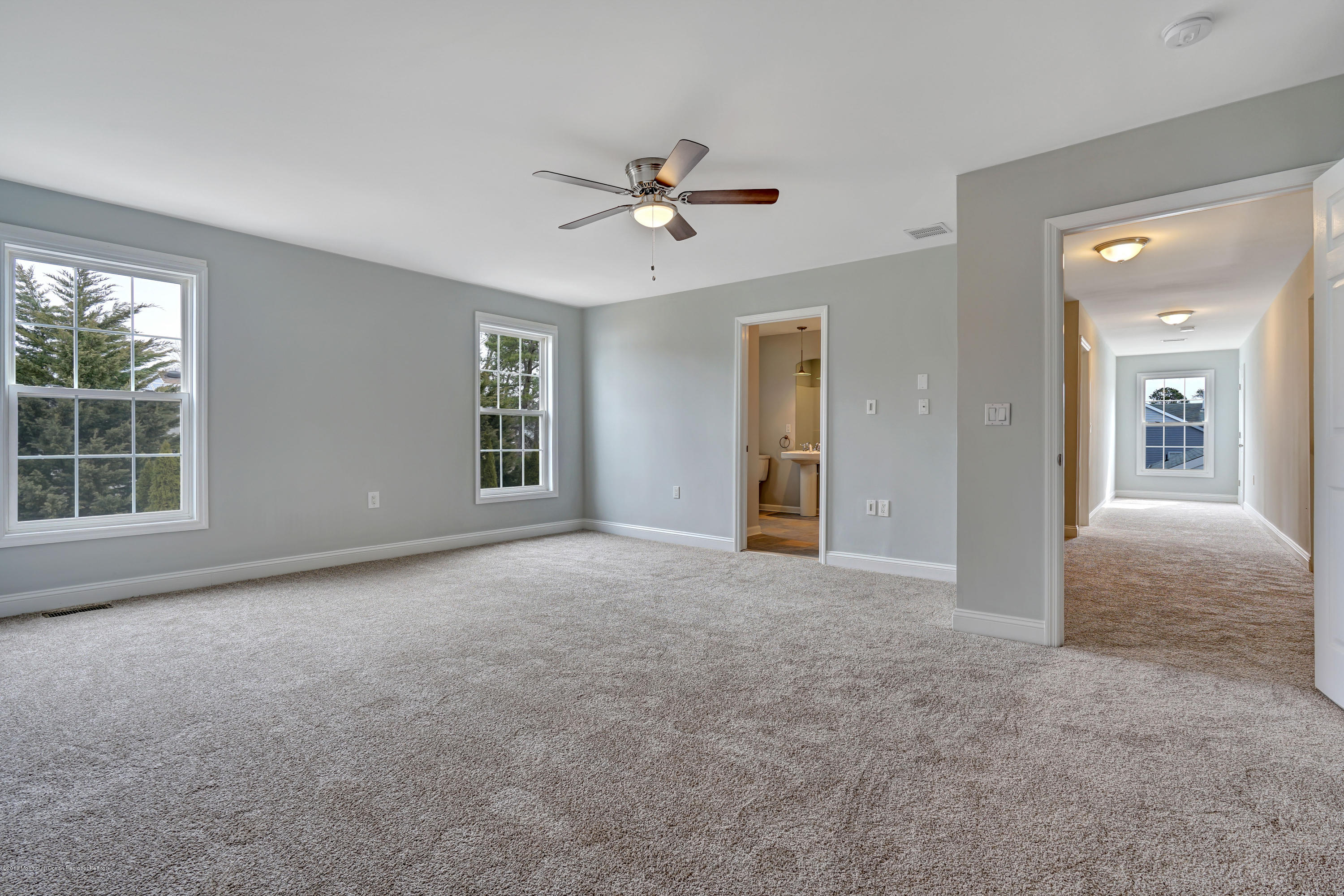 152 Bowline Road Manahawkin, NJ 08050 - Photo 26 of 29 a view of a big room with windows and chandelier fan