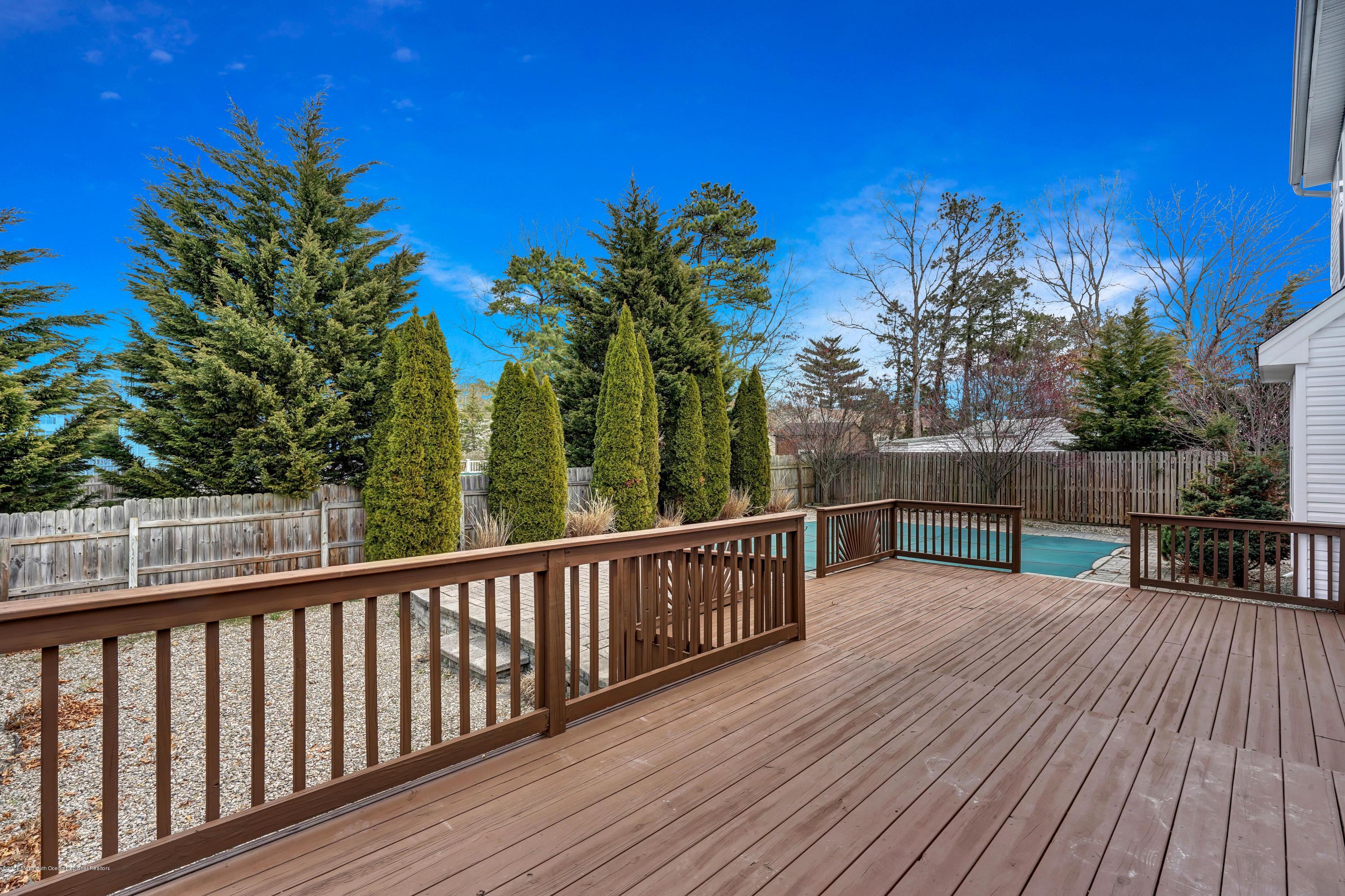 152 Bowline Road Manahawkin, NJ 08050 - Photo 27 of 29 a view of a balcony with wooden floor and fence
