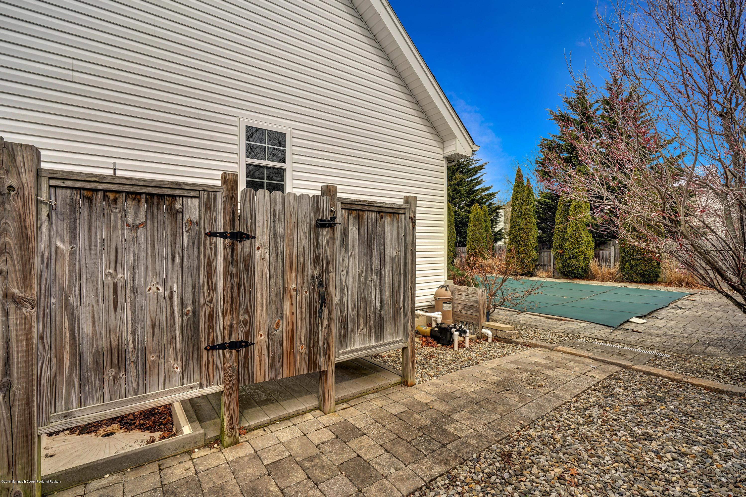 152 Bowline Road Manahawkin, NJ 08050 - Photo 29 of 29 a view of a house with backyard and a chair