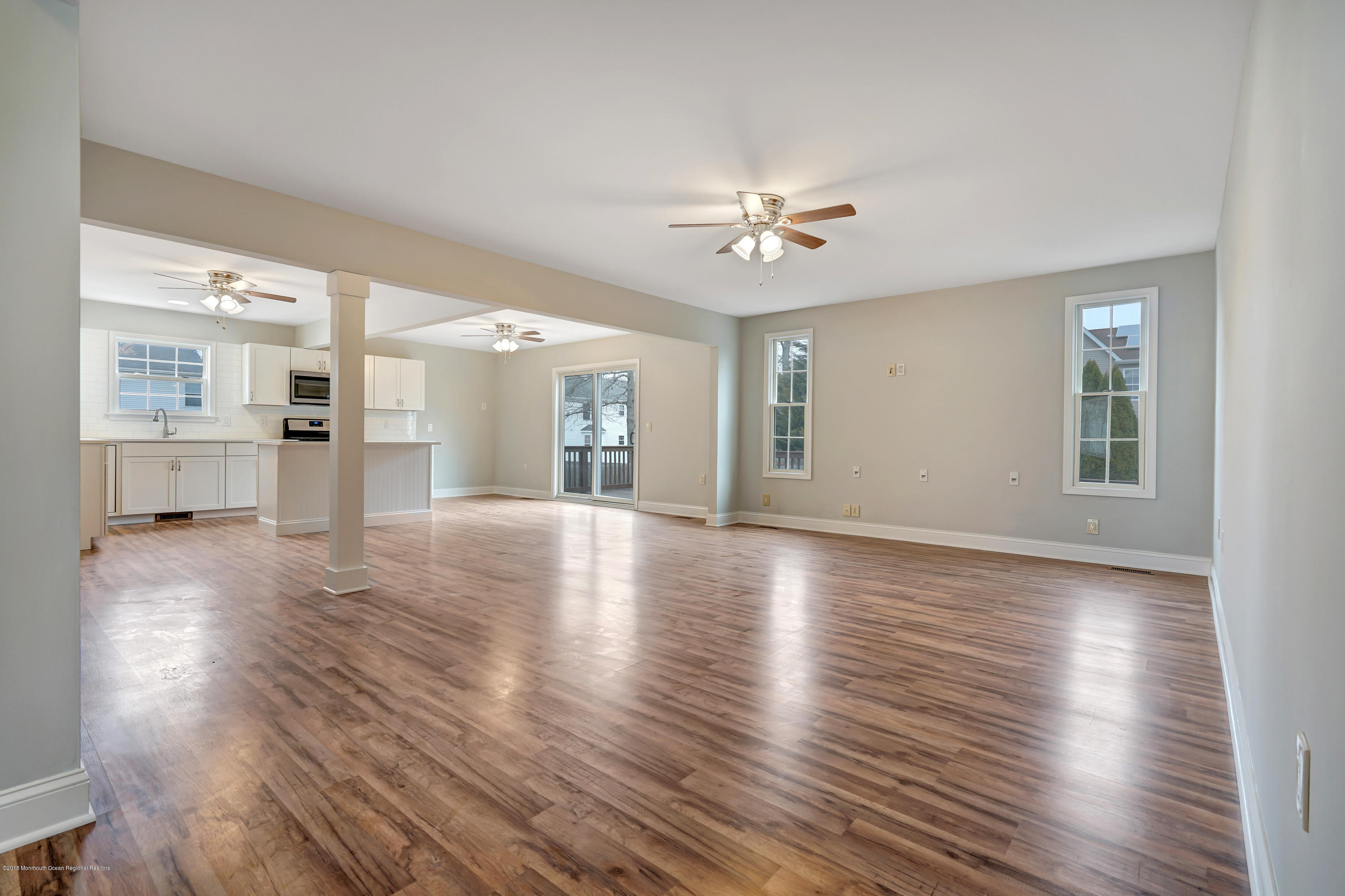 152 Bowline Road Manahawkin, NJ 08050 - Photo 6 of 29 a view of empty room with wooden floor and windows