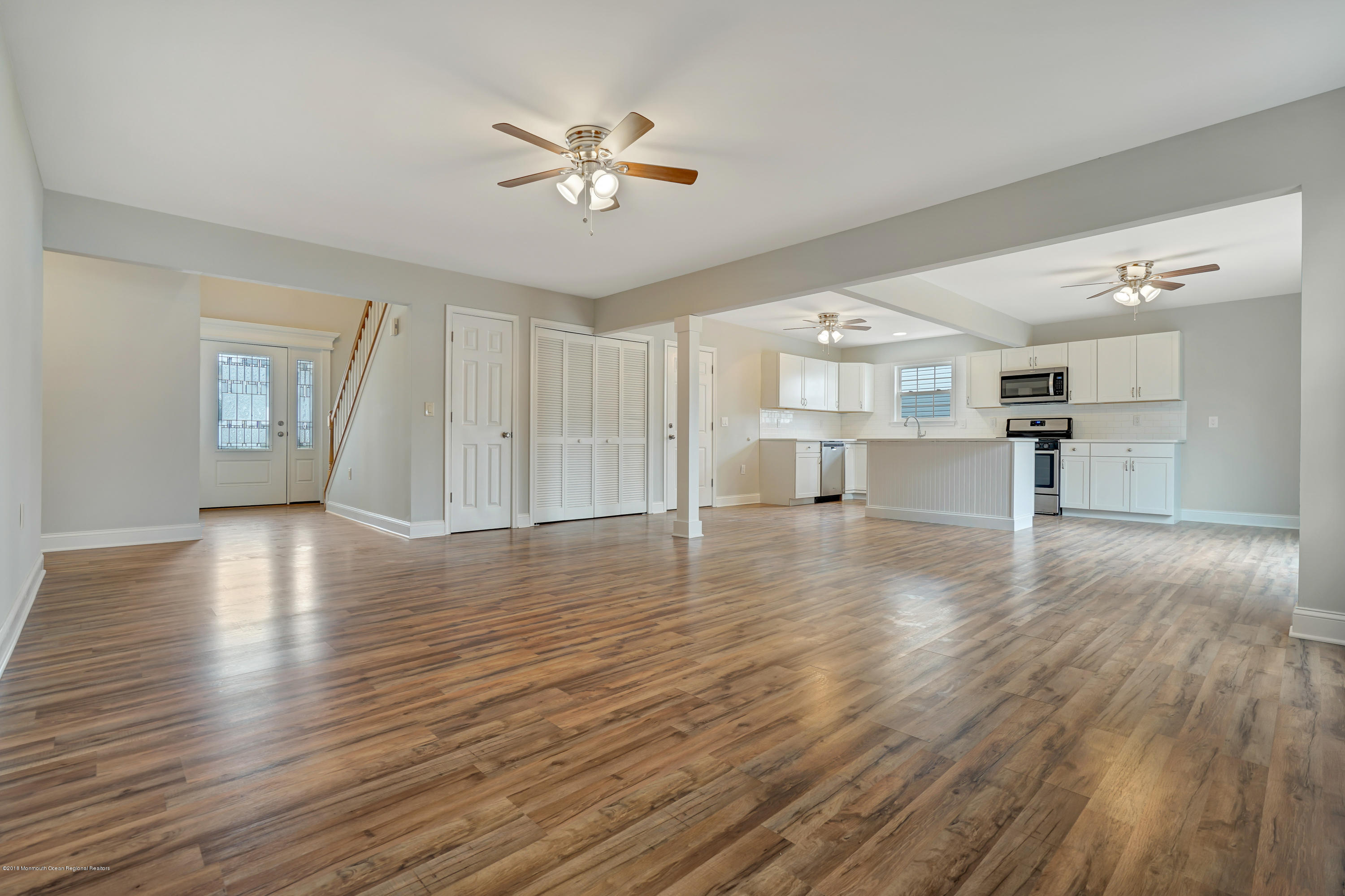 152 Bowline Road Manahawkin, NJ 08050 - Photo 7 of 29 a view of empty room with wooden floor and kitchen view