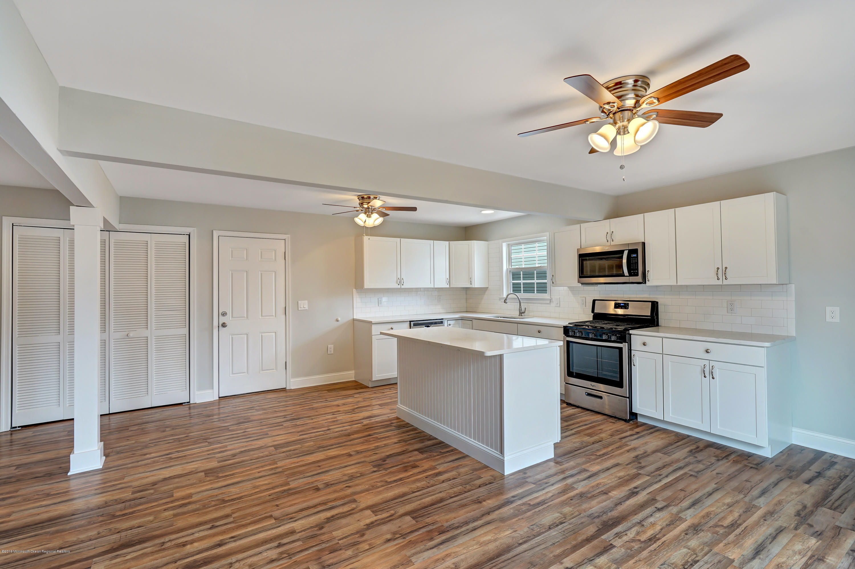152 Bowline Road Manahawkin, NJ 08050 - Photo 8 of 29 a kitchen with stainless steel appliances granite countertop a sink cabinets and wooden floor