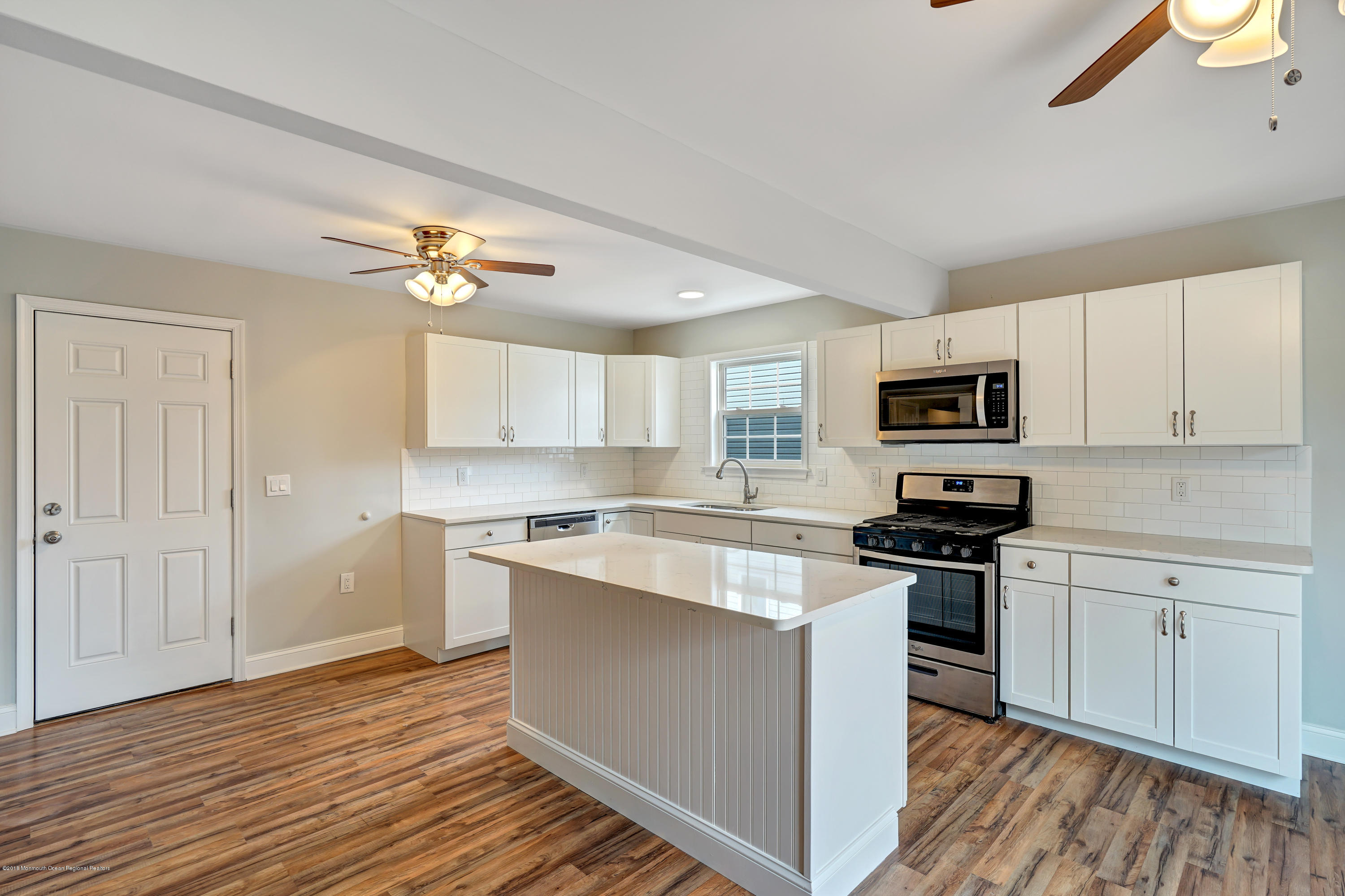 152 Bowline Road Manahawkin, NJ 08050 - Photo 10 of 29 a kitchen with cabinets wooden floor and appliances