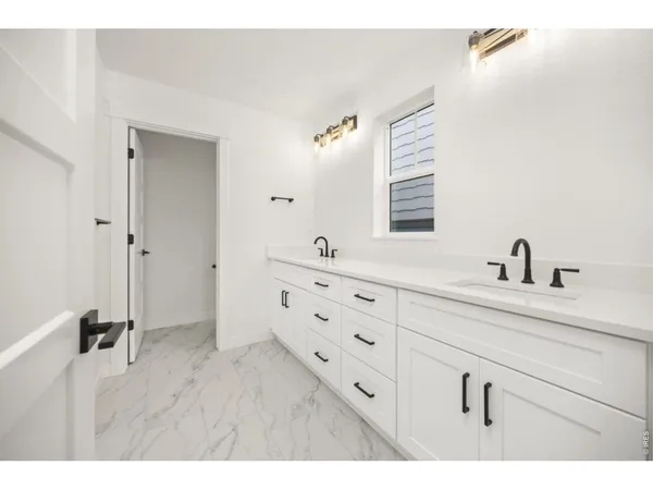 a bathroom with a double vanity sink and mirror