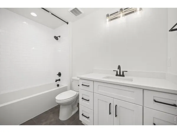 a bathroom with a sink a toilet and a tub