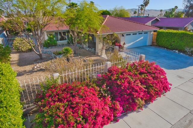 68110 Risueno Road Cathedral City, CA 92234 - Photo 21 of 33 a front view of a house with a yard and fountain