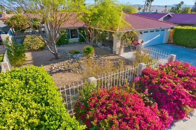 68110 Risueno Road Cathedral City, CA 92234 - Photo 22 of 33 a view of a house with a yard and garden