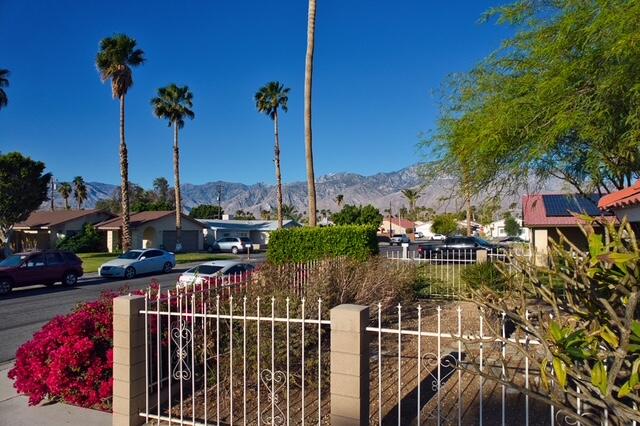 68110 Risueno Road Cathedral City, CA 92234 - Photo 25 of 33 a view of a house with a floor to ceiling window and palm tree