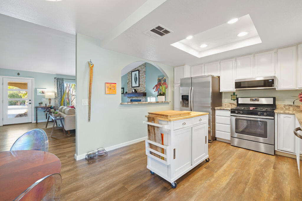 68110 Risueno Road Cathedral City, CA 92234 - Photo 6 of 33 a kitchen with a stove a sink and a refrigerator