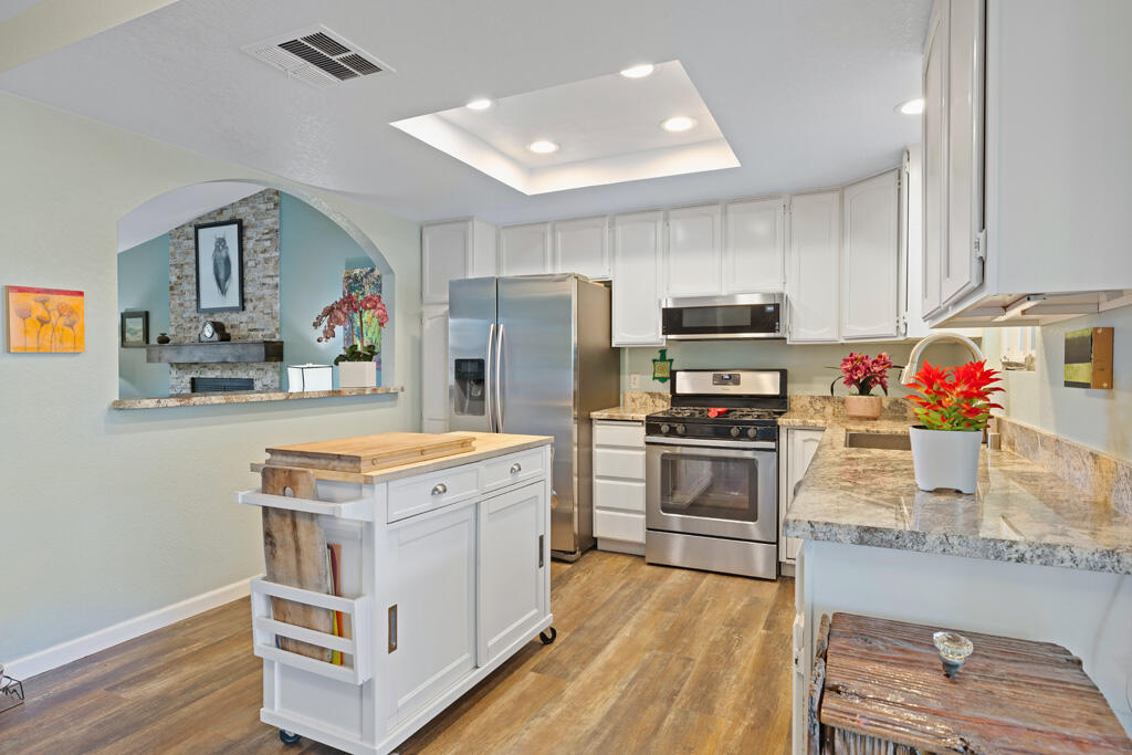68110 Risueno Road Cathedral City, CA 92234 - Photo 8 of 33 a kitchen with kitchen island a sink stove and refrigerator