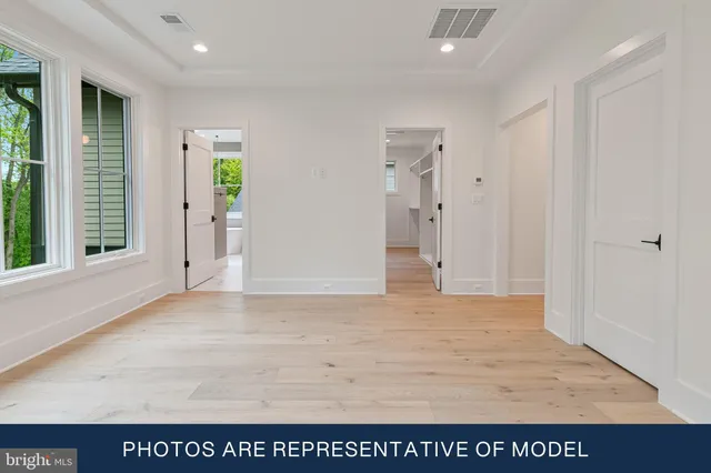 a bathroom with a sink a toilet and a large window
