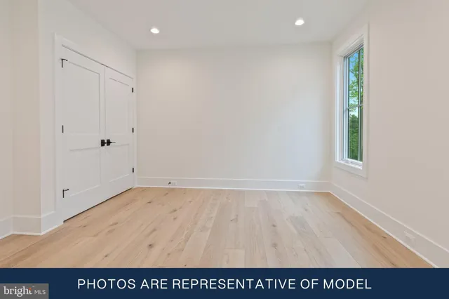 a kitchen with white cabinets and appliances