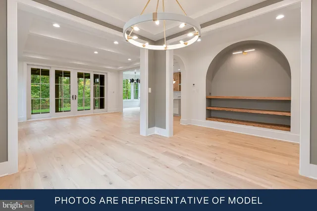 a view of kitchen and empty room with fireplace