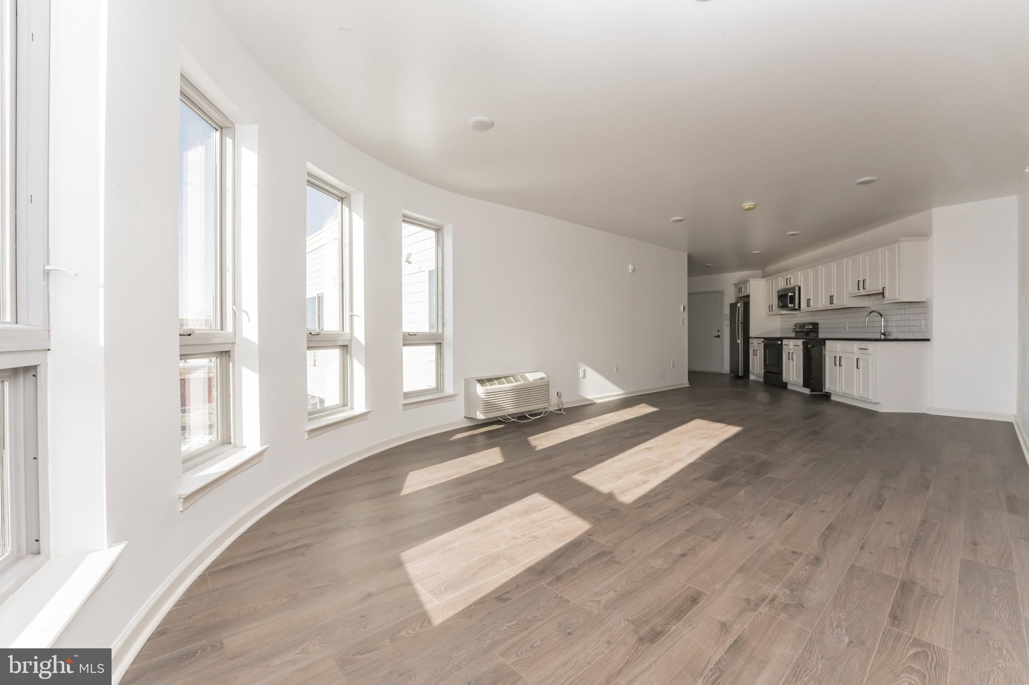 6649 Ridge Avenue, Unit A301 Philadelphia, PA 19128 - Photo 3 of 8 a view of livingroom with furniture and windows