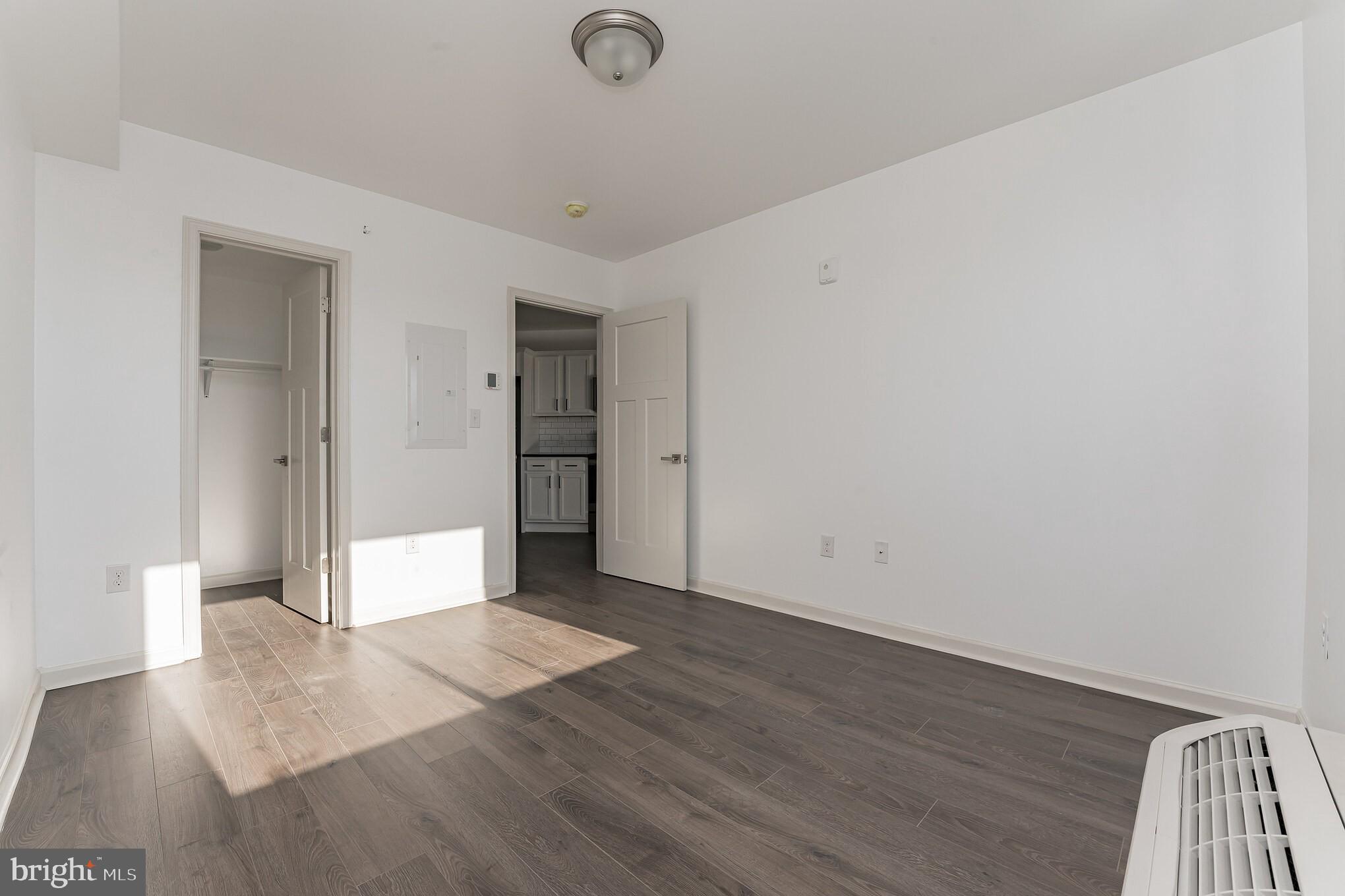 6649 Ridge Avenue, Unit A301 Philadelphia, PA 19128 - Photo 7 of 8 wooden floor in an empty room