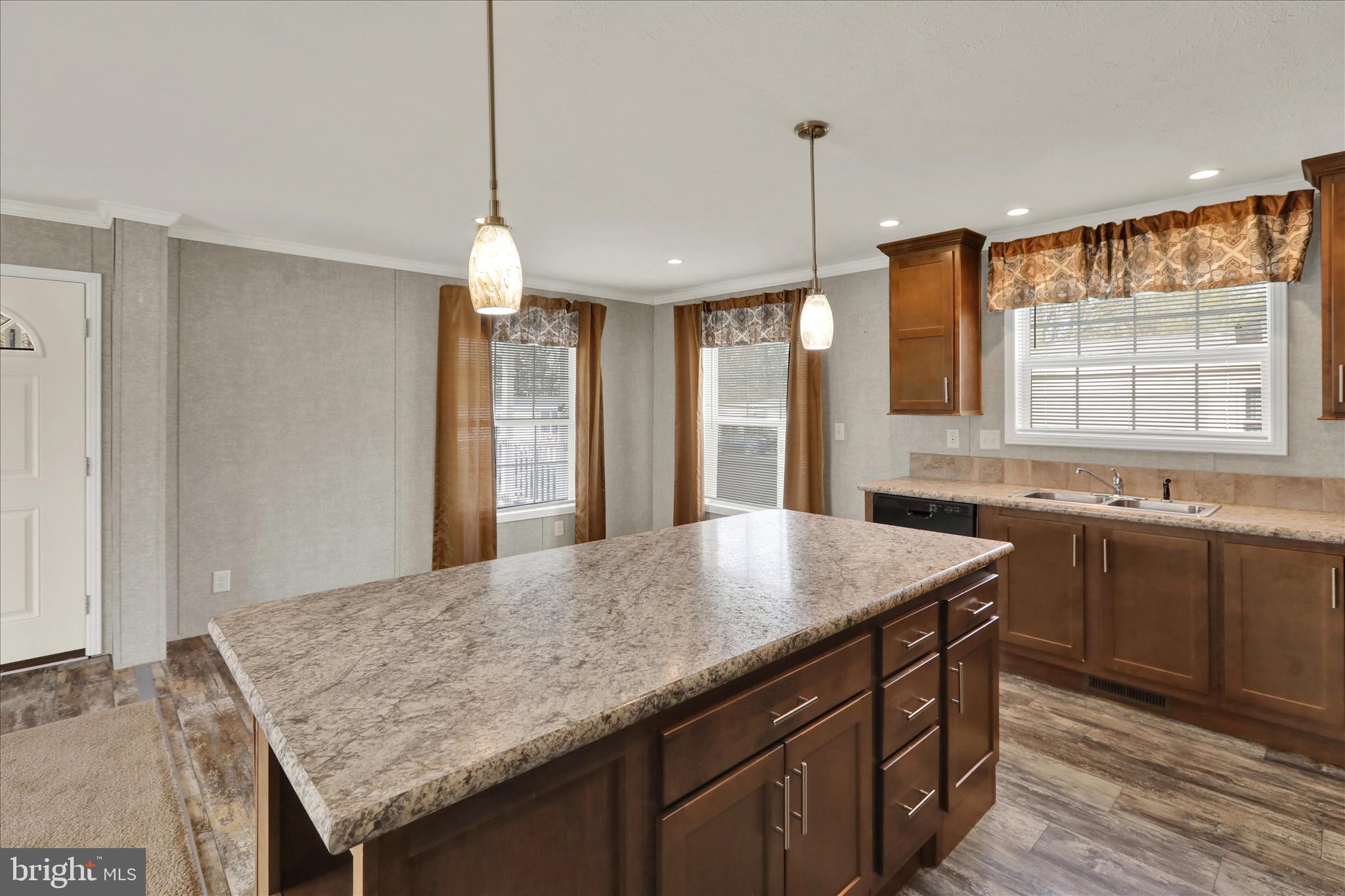 3450 Mountain Road, Unit M59 Hamburg, PA 19526 - Photo 11 of 35 a kitchen with a stove a sink dishwasher a kitchen island with wooden cabinets and floor