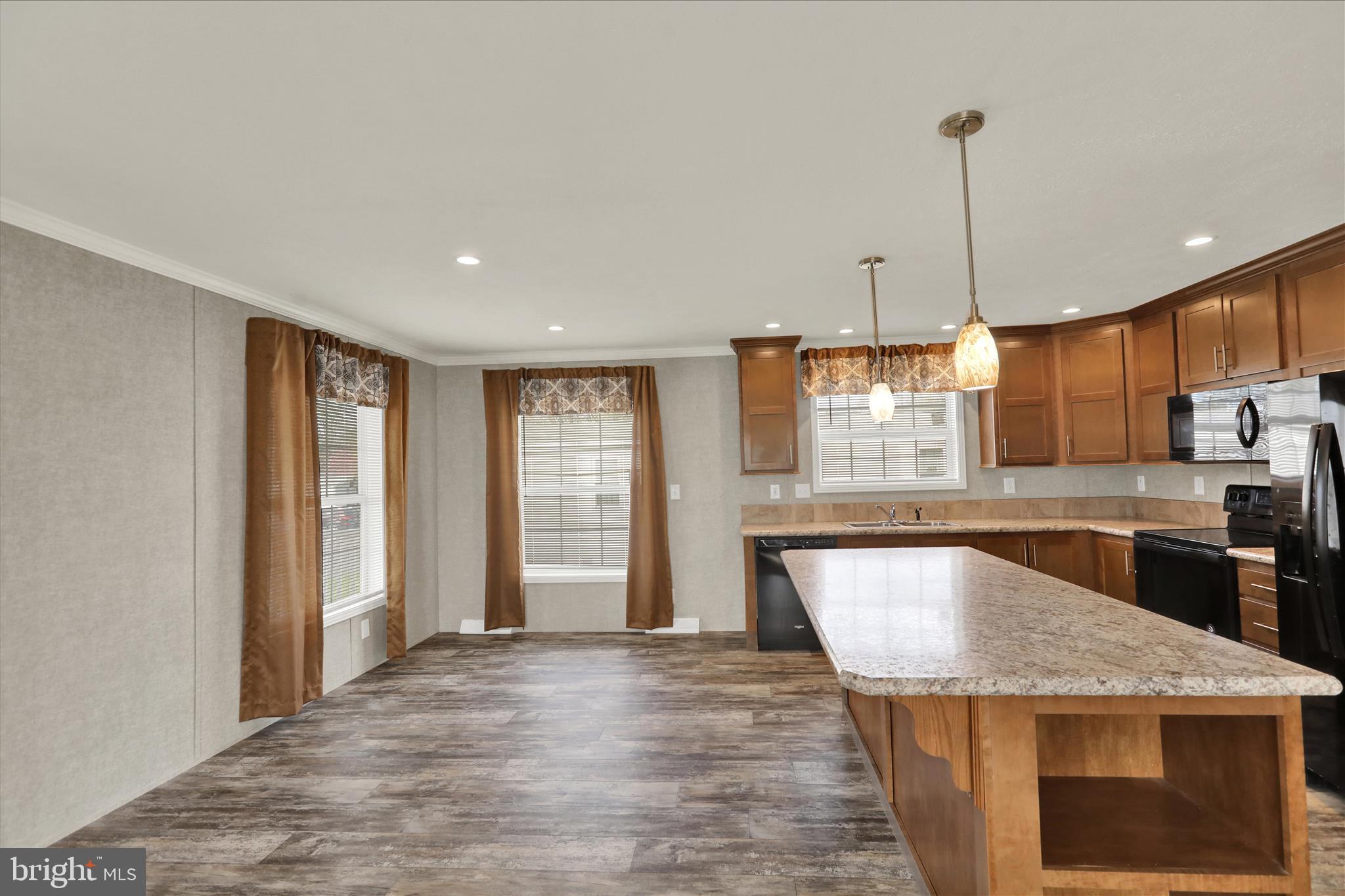 3450 Mountain Road, Unit M59 Hamburg, PA 19526 - Photo 13 of 35 a kitchen with stainless steel appliances granite countertop a sink a stove and a wooden floors