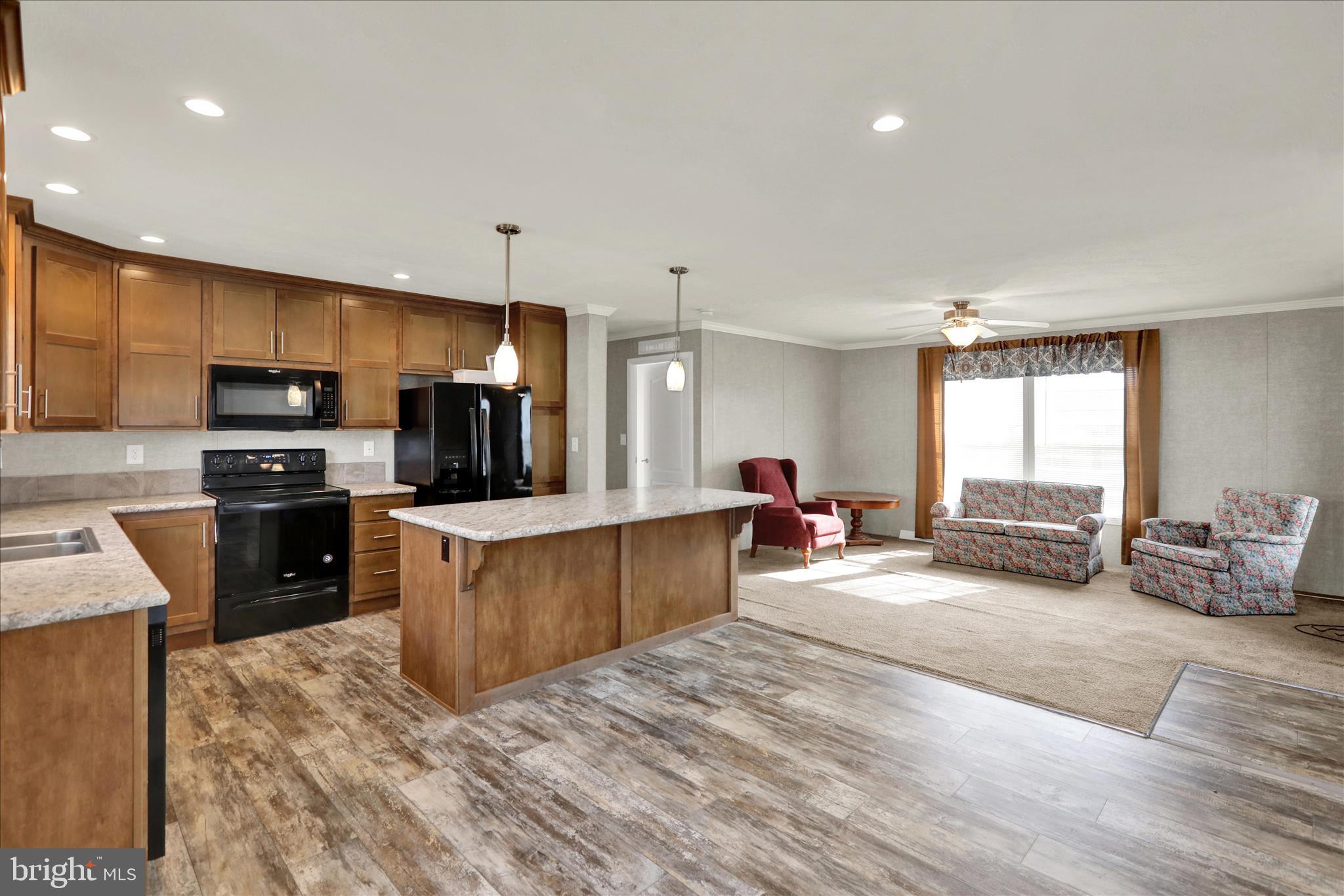 3450 Mountain Road, Unit M59 Hamburg, PA 19526 - Photo 14 of 35 a large kitchen with stainless steel appliances kitchen island granite countertop a large counter top cabinets and refrigerator