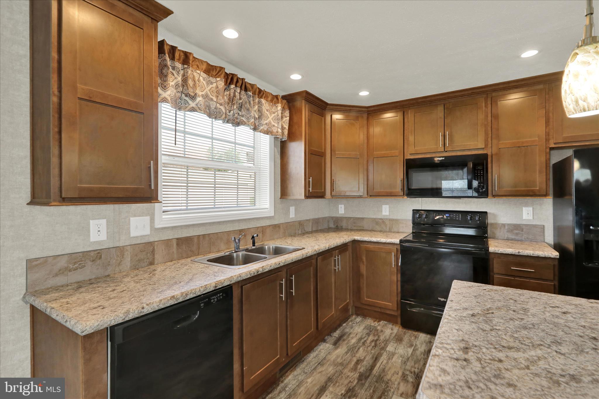 3450 Mountain Road, Unit M59 Hamburg, PA 19526 - Photo 15 of 35 a kitchen with a sink stove and microwave
