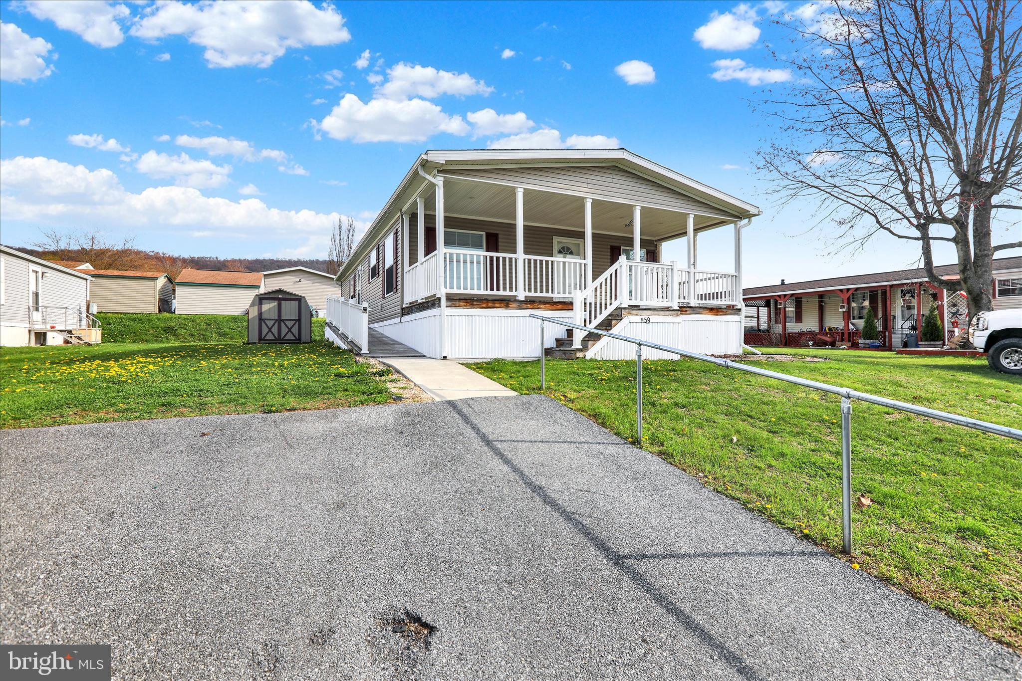 3450 Mountain Road, Unit M59 Hamburg, PA 19526 - Photo 2 of 35 a view of a house with a yard and sitting area