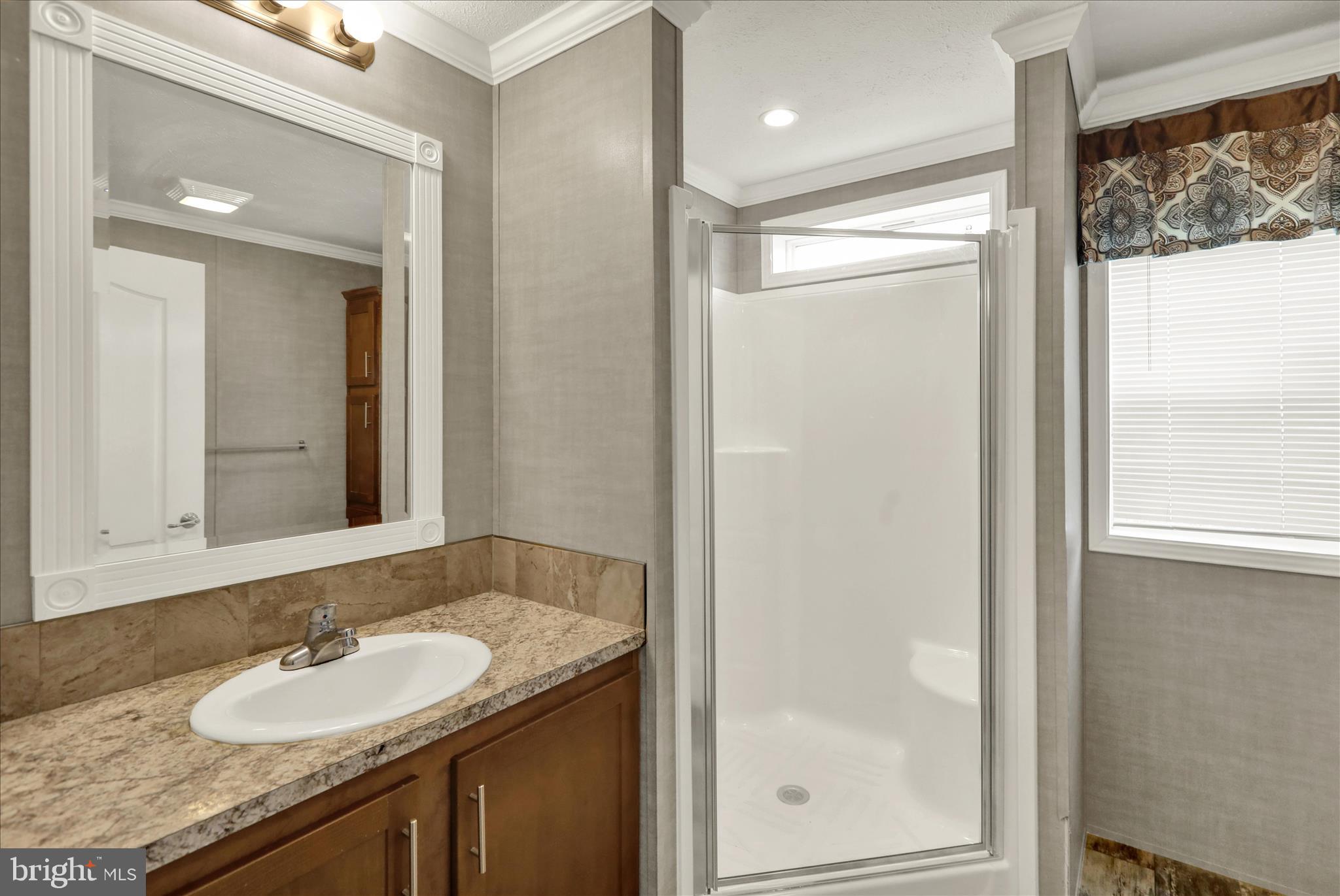 3450 Mountain Road, Unit M59 Hamburg, PA 19526 - Photo 26 of 35 a bathroom with a granite countertop sink and a mirror