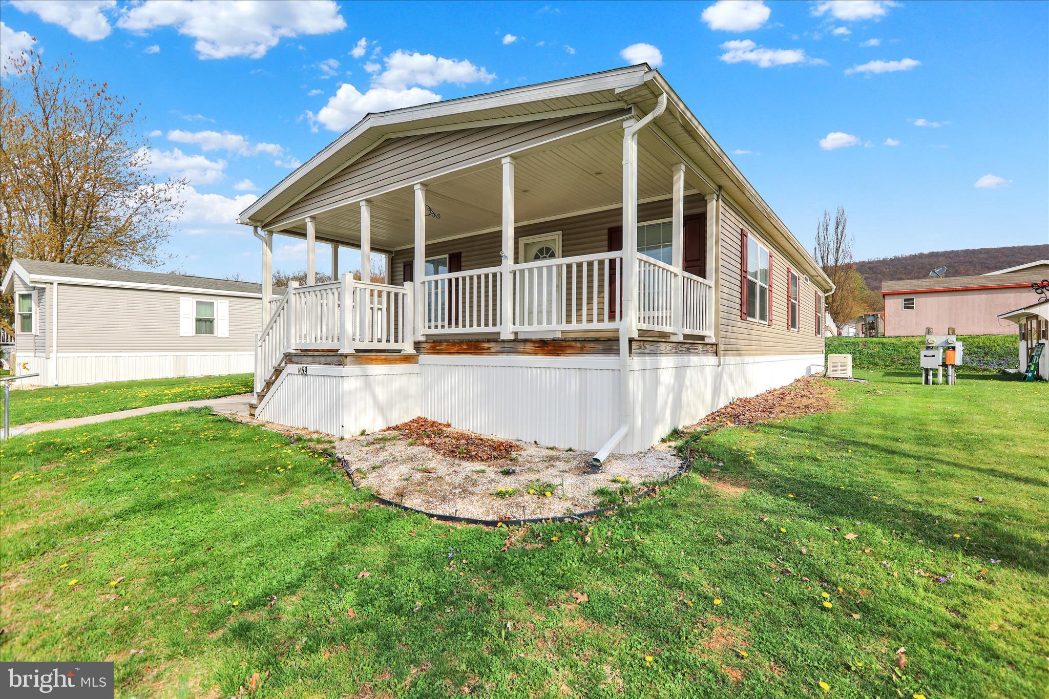 3450 Mountain Road, Unit M59 Hamburg, PA 19526 - Photo 5 of 35 a view of a house with a yard and sitting area