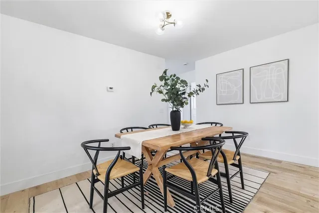 a view of a table and chairs in wooden floor