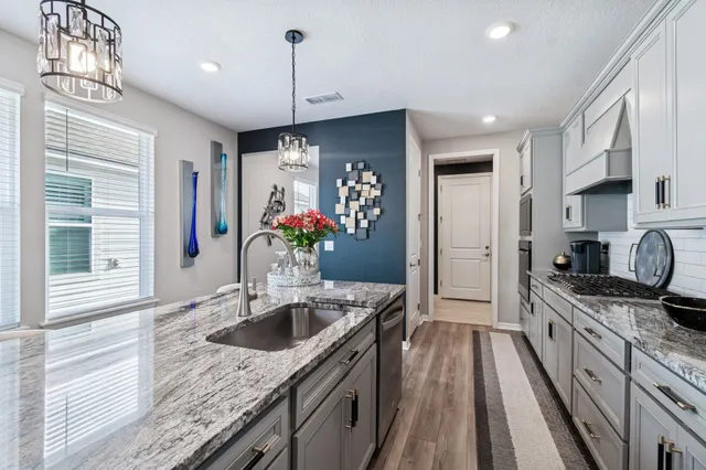 a view of a backyard with plants and sitting area