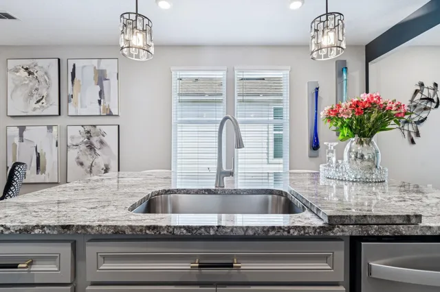 a front view of multi story residential apartment building with a yard and palm trees