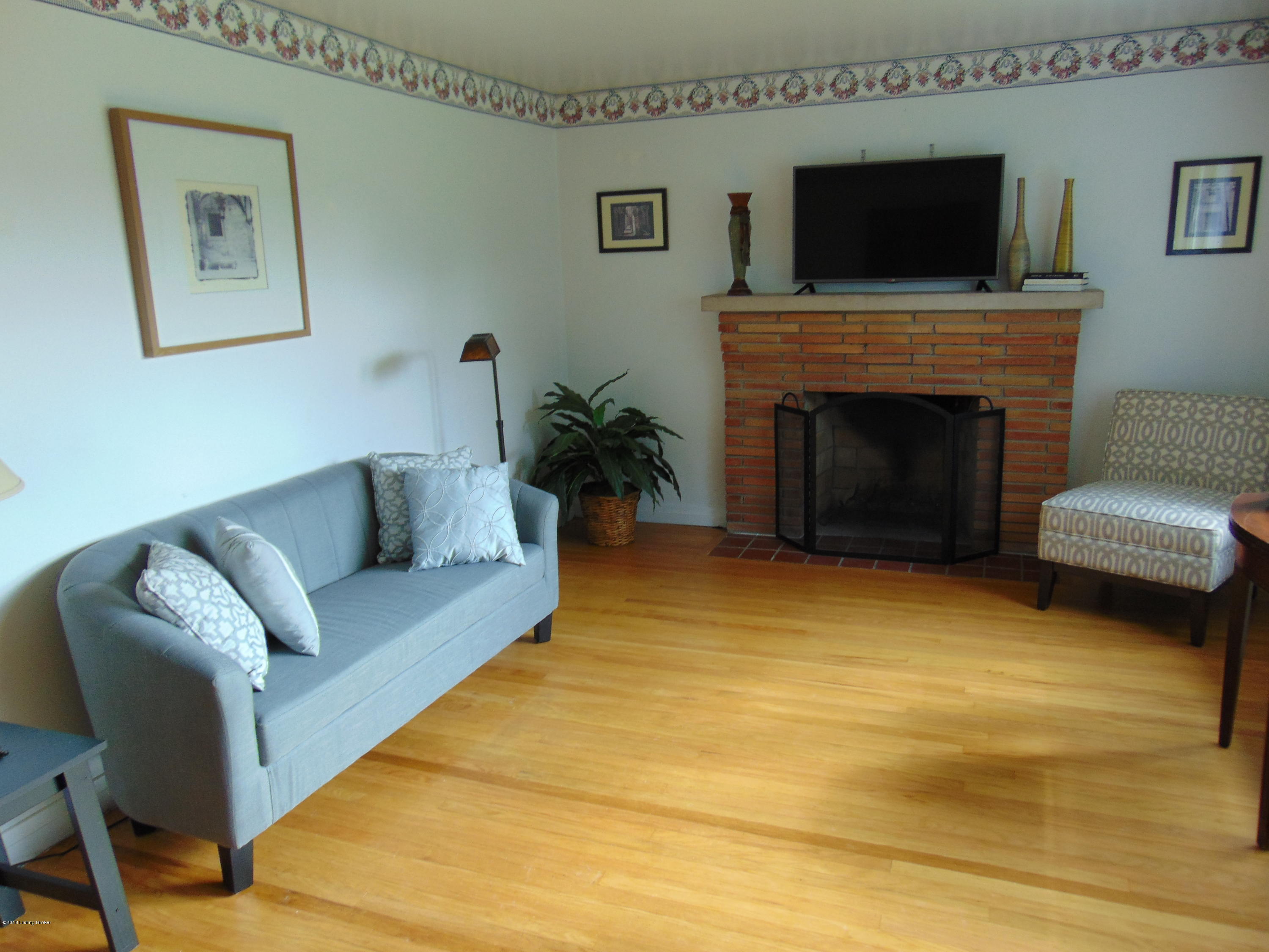 4405 Leeds Road Louisville, KY 40216 - Photo 14 of 58 Classic brick fireplace with tiled hearth