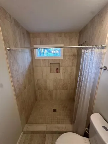 a bathroom with a shower and a toilet