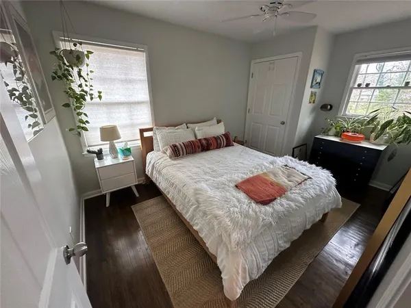 a bedroom with a bed mirror and window