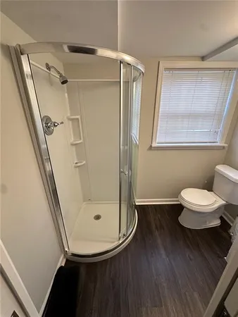 a bathroom with a toilet and a shower