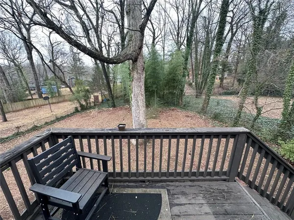 a view of a roof deck with wooden floor and fence