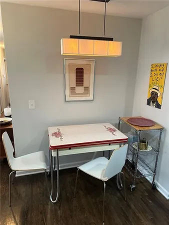 a room with table chairs and wooden floor