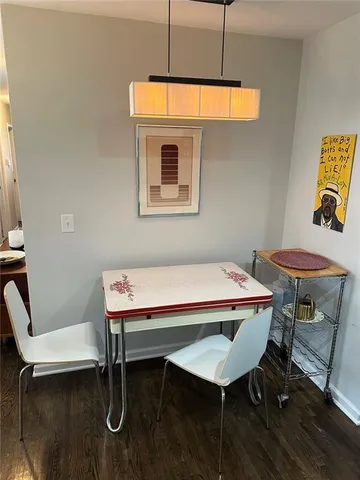 a room with table chairs and wooden floor