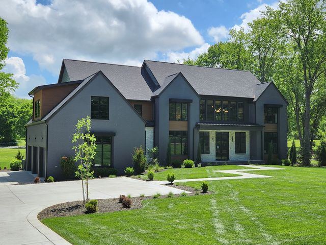 a view of a brick house with a black gate