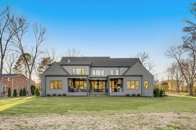 a kitchen with stainless steel appliances a stove a refrigerator a oven a sink with island and chairs