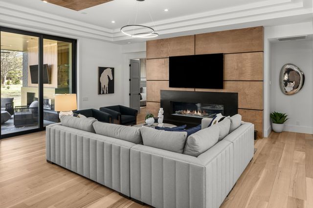 a kitchen with stainless steel appliances a refrigerator and wooden floor